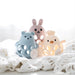 Three colorful animal-shaped toys on a textured white surface