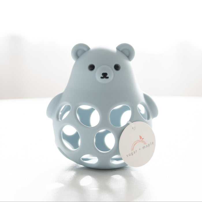 Blue bear-shaped teether toy with a white label on a light background