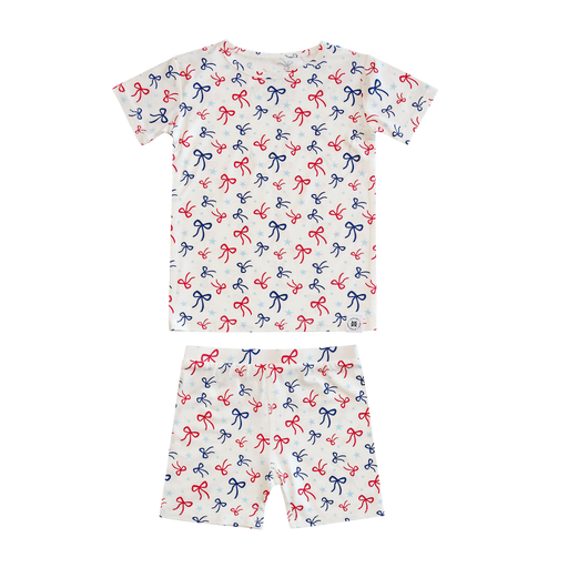 Children's pajama set with bow pattern on a white background