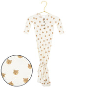 Baby onesie with bear pattern on a hanger against a white background