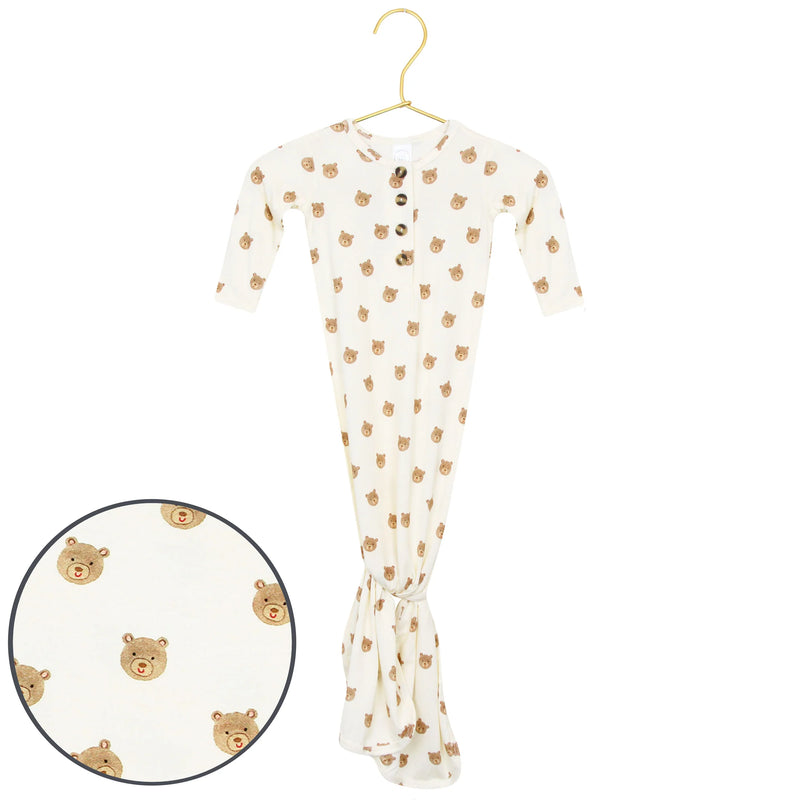 Baby onesie with bear pattern on a hanger against a white background