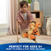 Child playing on the floor with Oh So Snuggly Tigger plush