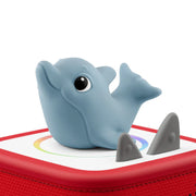Blue rubber dolphin on a red stand with a white background