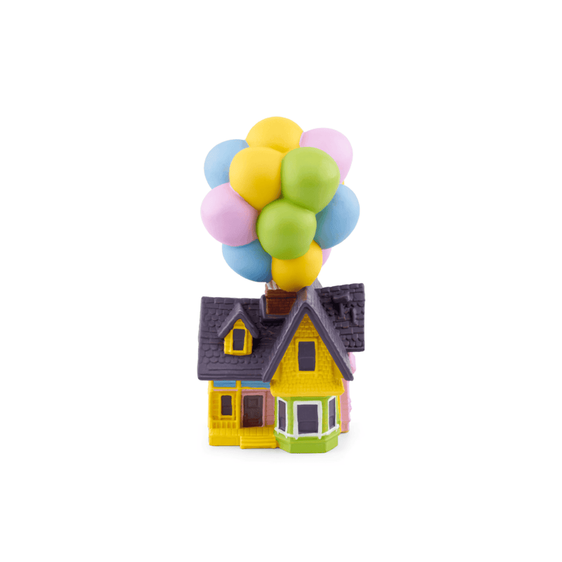 Small model house with colorful balloons on a white background