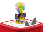 Toy house with balloons on a red base with shark fins, against a transparent background