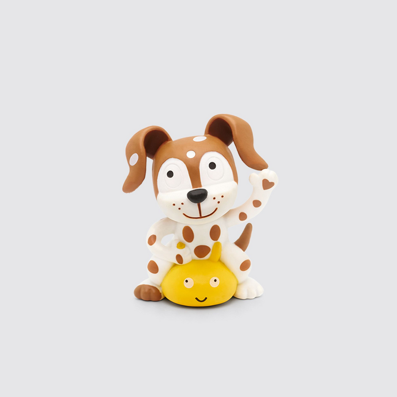 A figurine of a cartoon dog with a polka dot pattern, sitting and holding a yellow object.