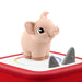 Toy pig on top of a red tonies box  on a white background