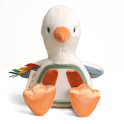 Plush toy duck with orange beak and feet on a white background