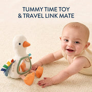 Baby playing with a toy duck on a textured surface, with text 'Tummy Time Toy & Travel Link Mate' above.