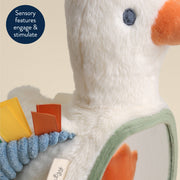 Close-up of a plush toy with sensory features on a beige background