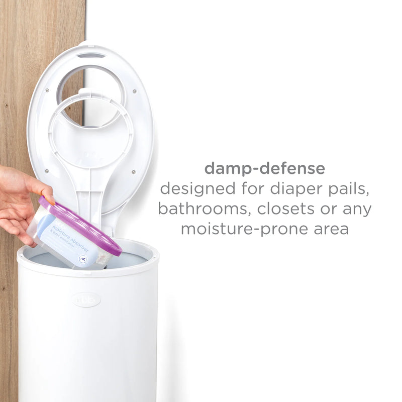 White diaper pail with a hand holding a purple lid, text indicating use in moisture-prone areas.