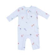Light blue long-sleeve uni romper laid flat on a gray background, featuring an allover fly-fishing lure print in orange, navy, and soft gray.