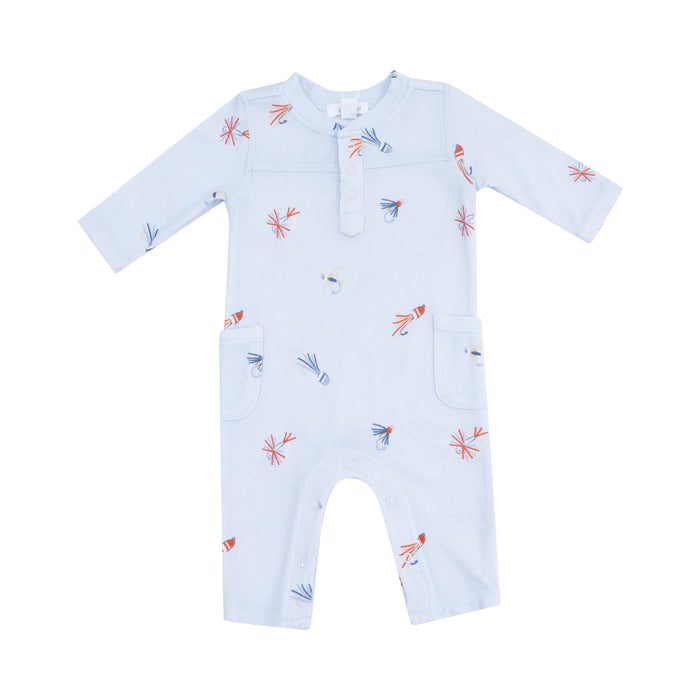 Light blue long-sleeve uni romper laid flat on a gray background, featuring an allover fly-fishing lure print in orange, navy, and soft gray.