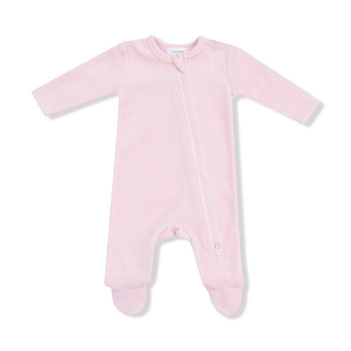 Pink velour footie with long sleeves and a diagonal zipper shown flat on a white background.