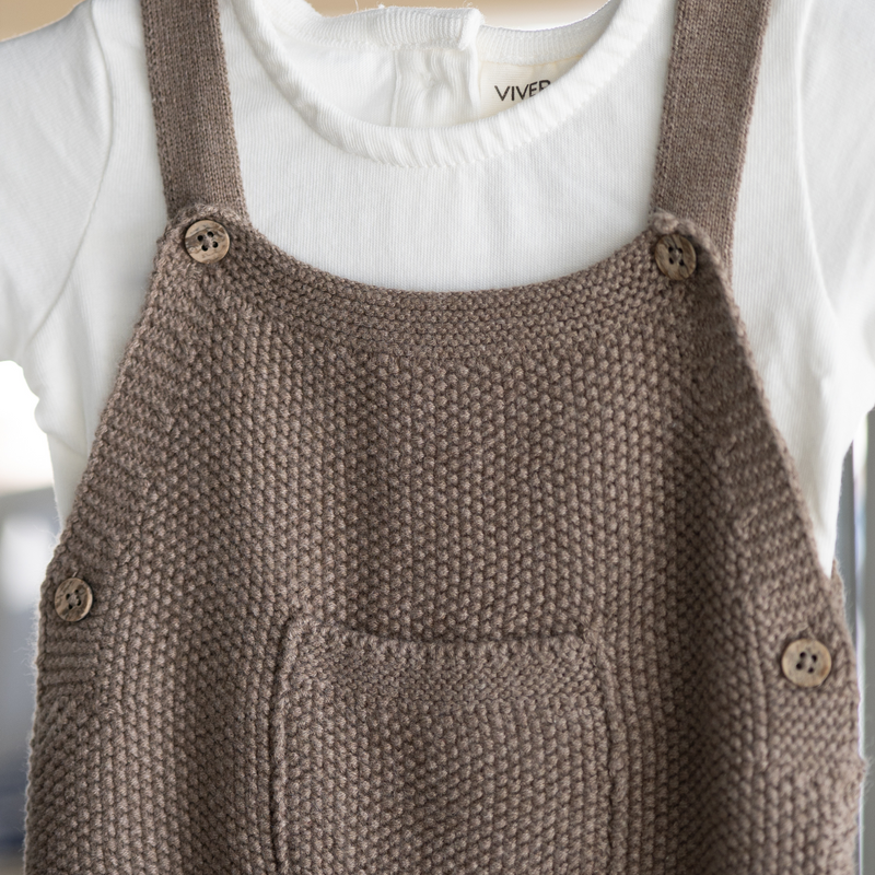 Brown knitted overall with buttons on a white background