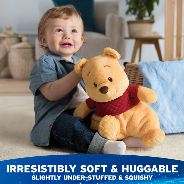 Child cuddling Oh So Snuggly Winnie the Pooh plush in a nursery