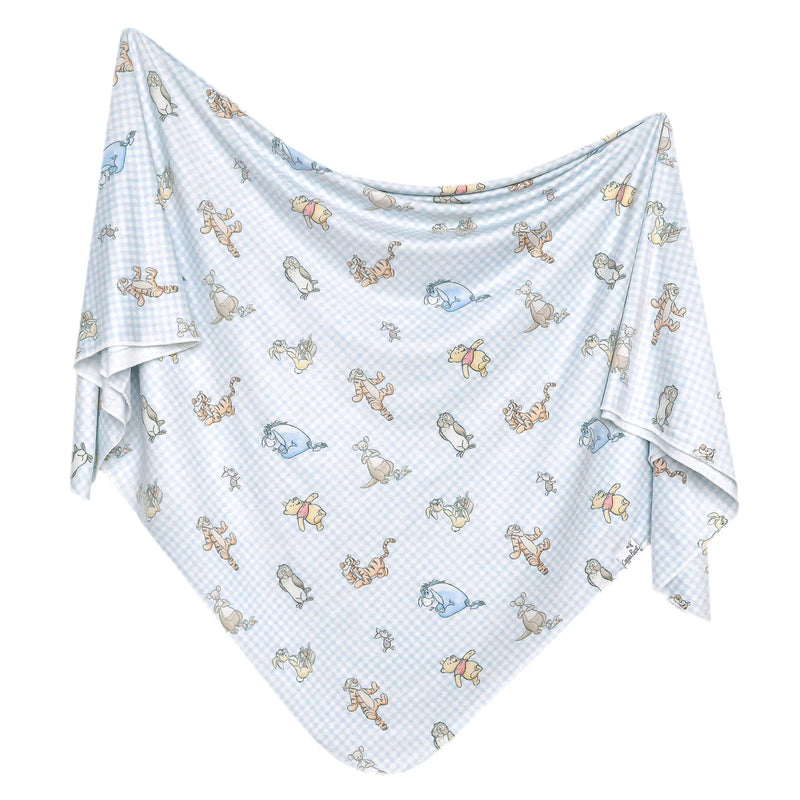 Baby blanket with winnie the pooh pattern on a white background