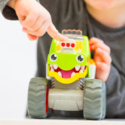 Child pressing the engine to open WOW Toys Mack Monster Truck's mouth