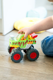 Child playing with WOW Toys Mack Monster Truck on the floor