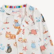 Baby clothing with cat and boat pattern on a white background