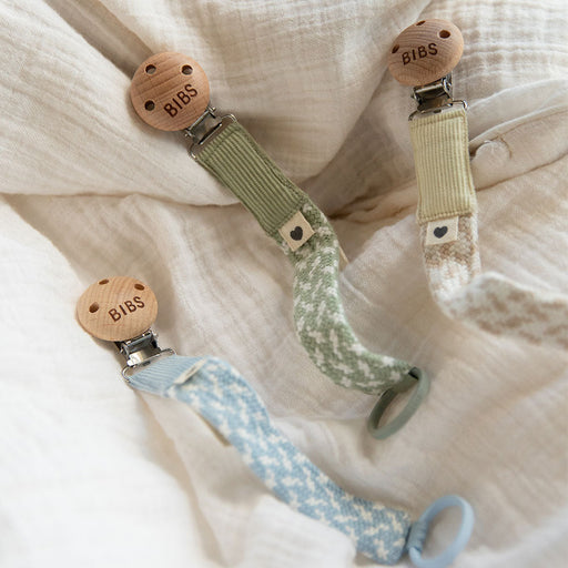 Multiple BIBS pacifier clips displayed together showing braided fabric design