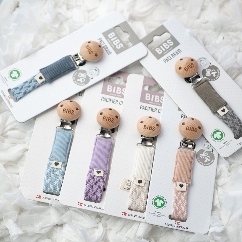 Assorted BIBS pacifier clips displayed on retail packaging cards